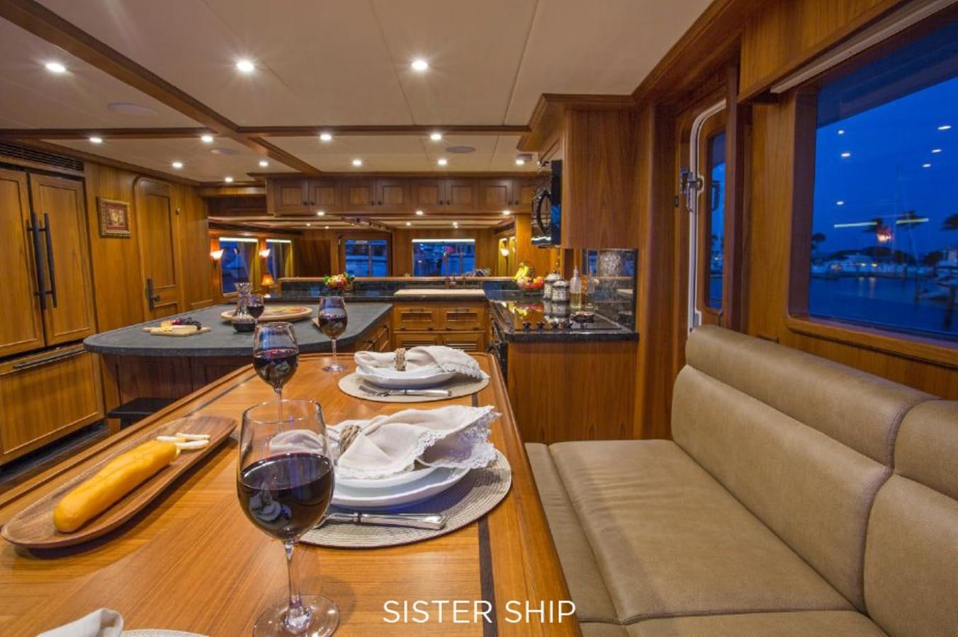a large kitchen with a table set aboard 820 CPMY Yacht for Sale