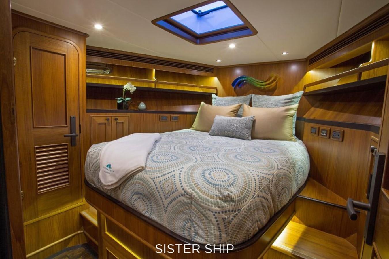 a bed with a wooden headboard aboard 820 CPMY Yacht for Sale