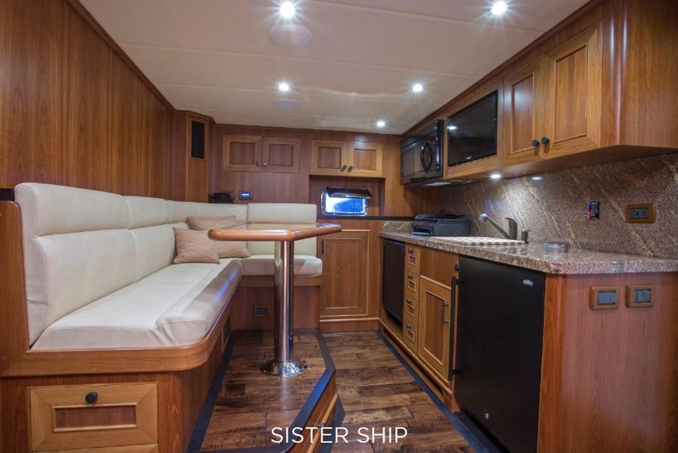 a kitchen with wooden cabinets aboard 820 CPMY Yacht for Sale