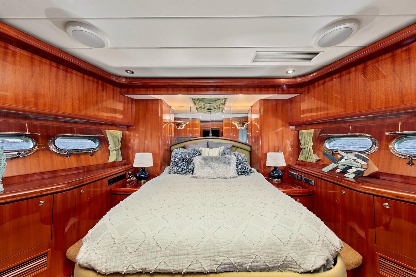 a bedroom with wooden furniture aboard PAPA'S PLACE Yacht for Sale