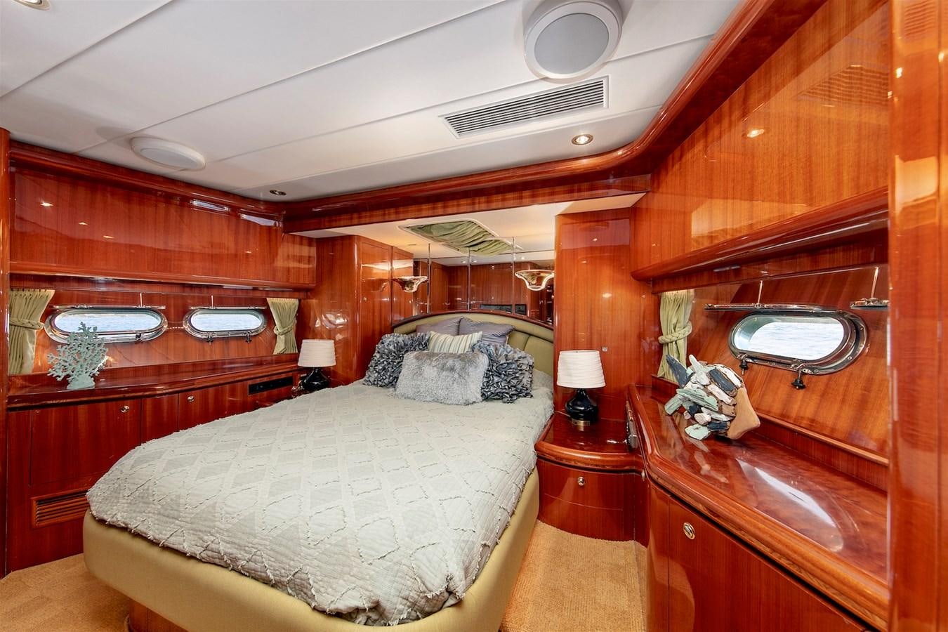 a bedroom with a bed and a dresser aboard PAPA'S PLACE Yacht for Sale
