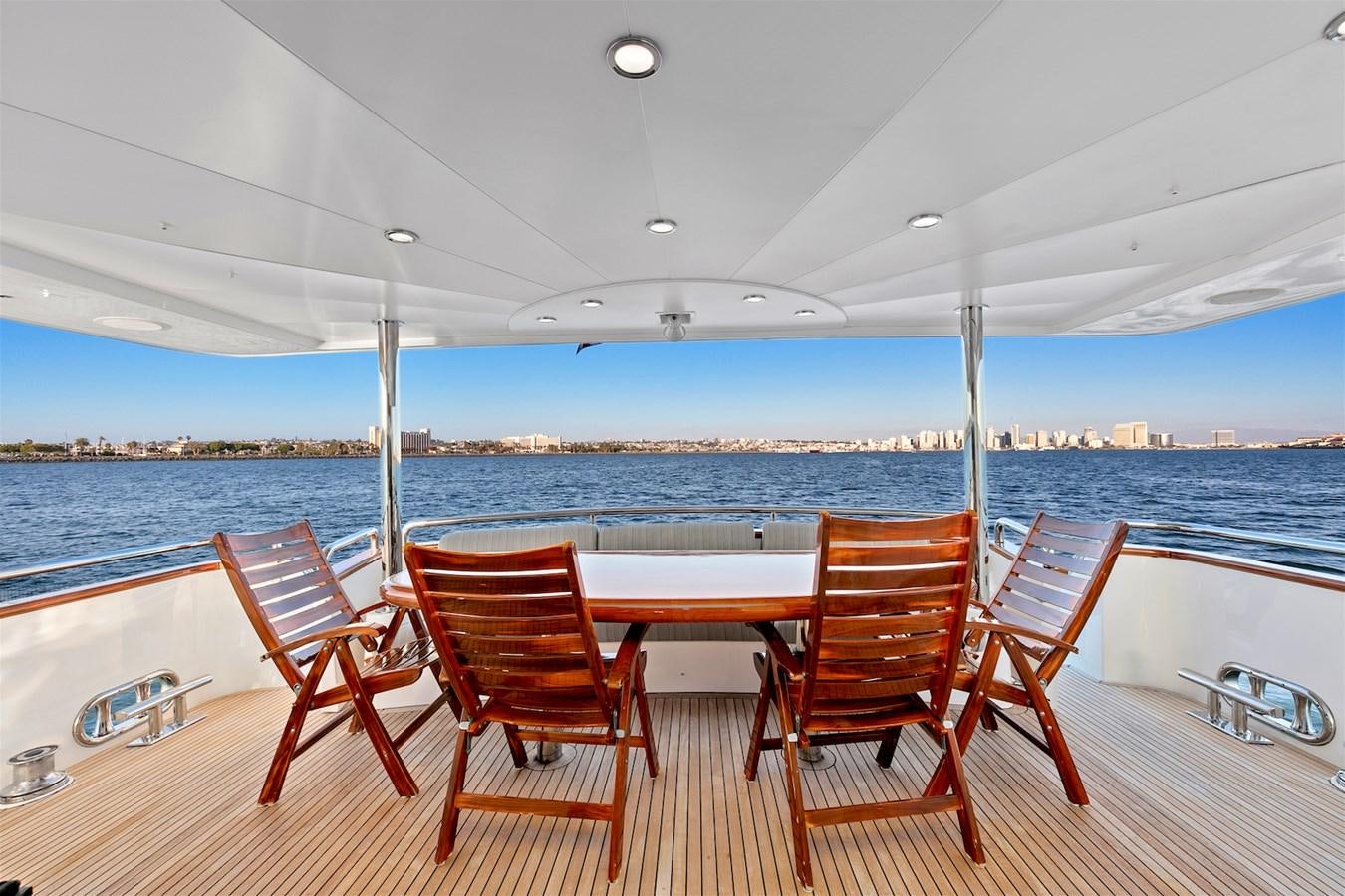 a group of chairs on a deck overlooking a body of water aboard PAPA'S PLACE Yacht for Sale