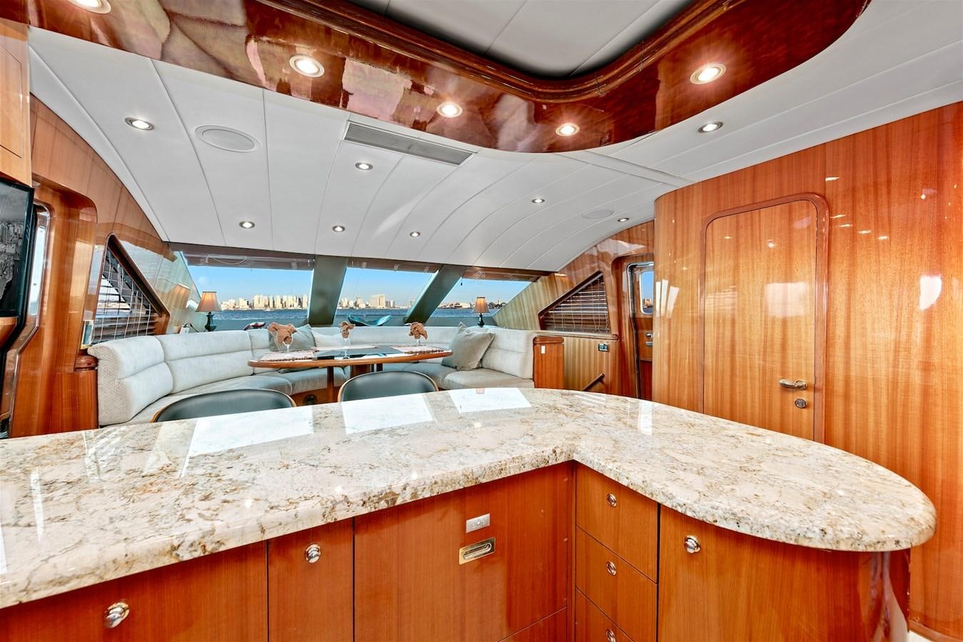 a large room with a large wood cabinet and a table aboard PAPA'S PLACE Yacht for Sale
