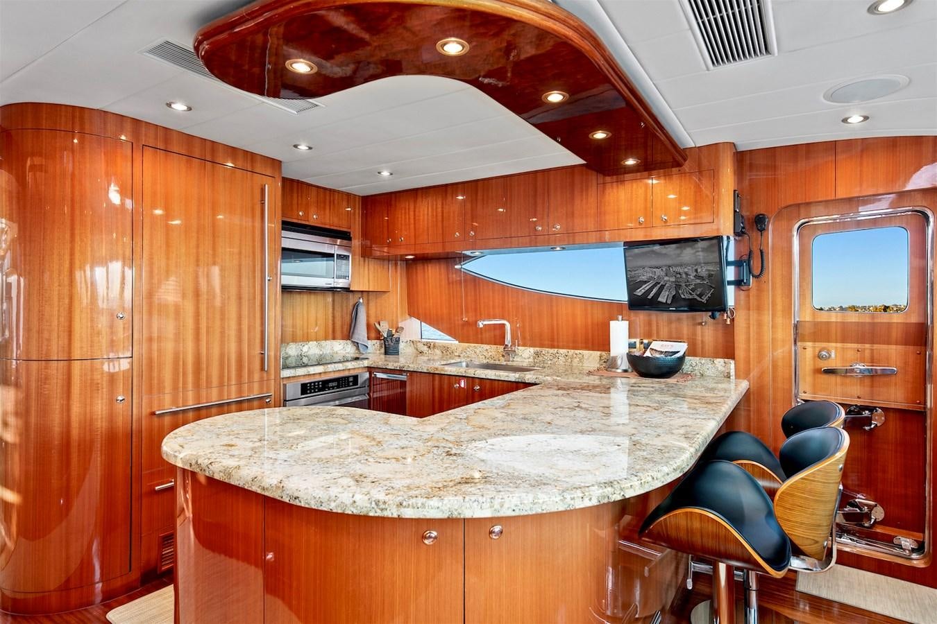 a kitchen with wooden cabinets aboard PAPA'S PLACE Yacht for Sale