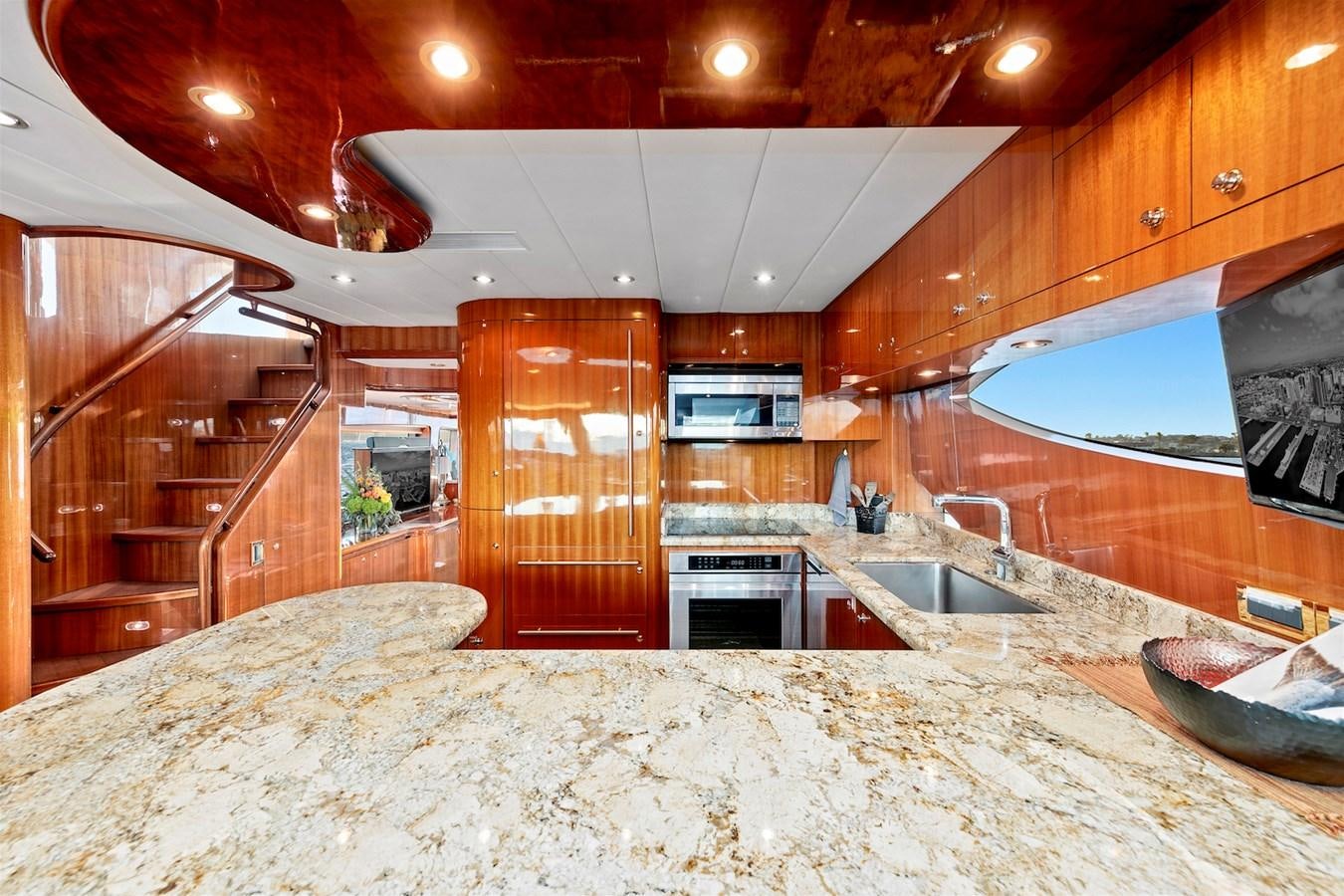 a large kitchen with wooden cabinets aboard PAPA'S PLACE Yacht for Sale