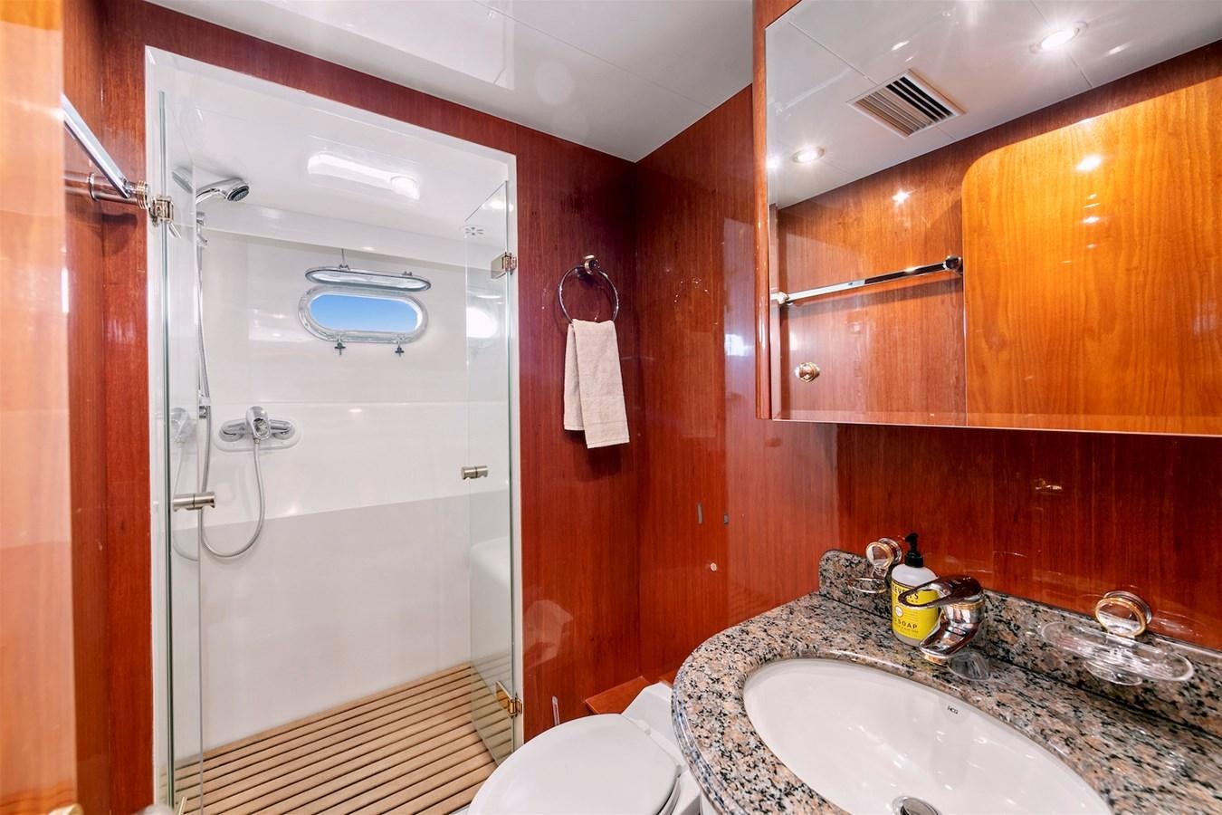 a bathroom with a shower and sink aboard PAPA'S PLACE Yacht for Sale