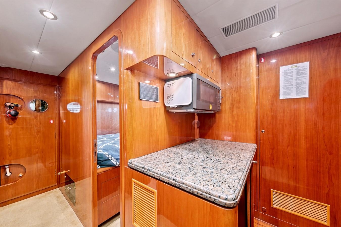 a kitchen with wooden cabinets aboard PAPA'S PLACE Yacht for Sale