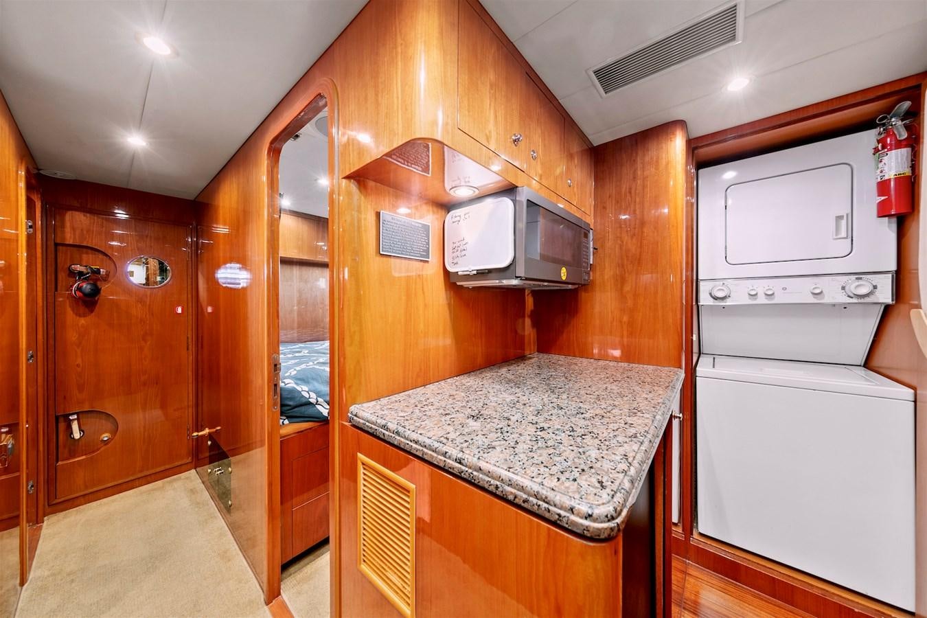 a kitchen with wooden cabinets aboard PAPA'S PLACE Yacht for Sale