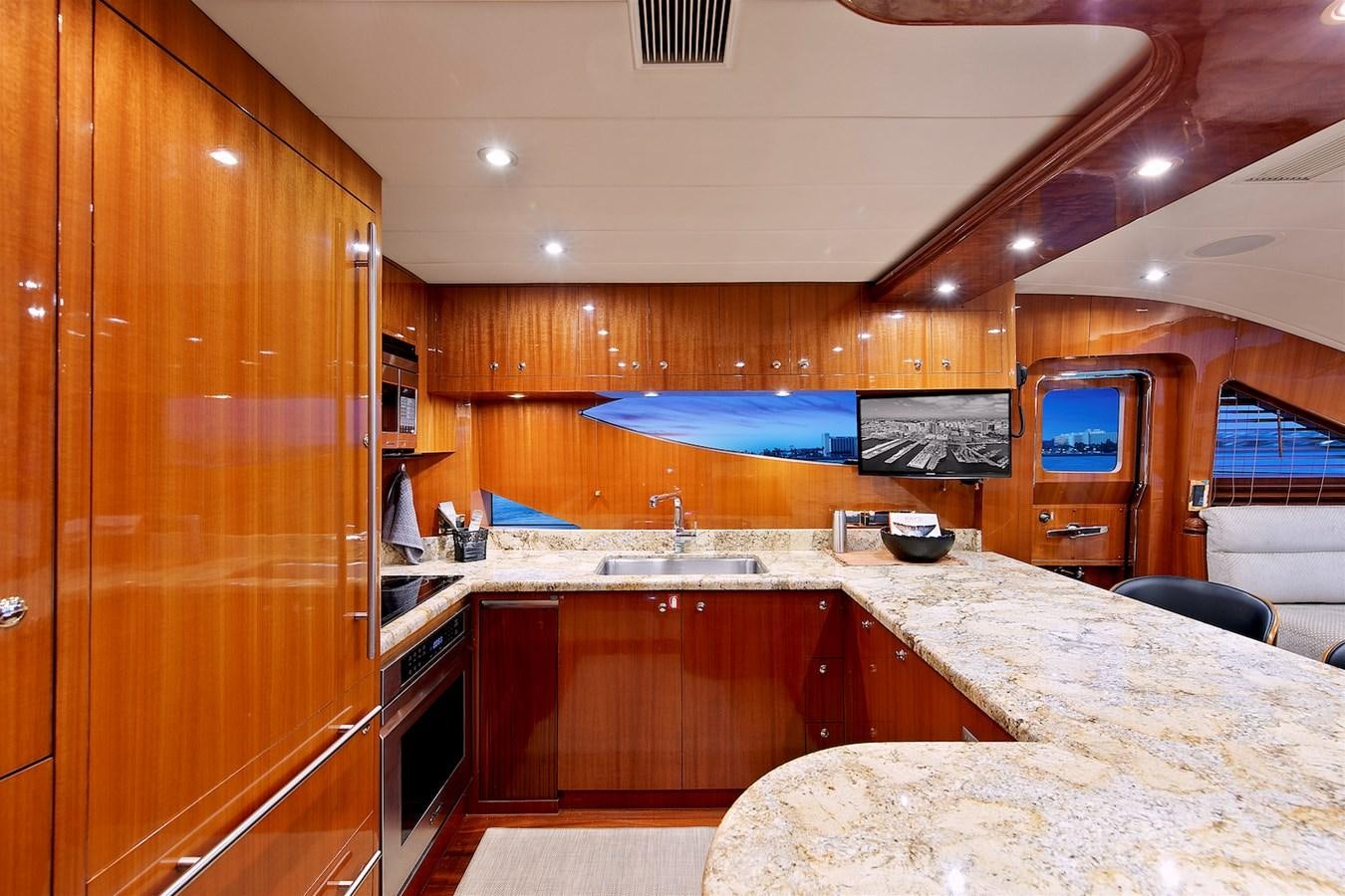 a kitchen with wooden cabinets aboard PAPA'S PLACE Yacht for Sale