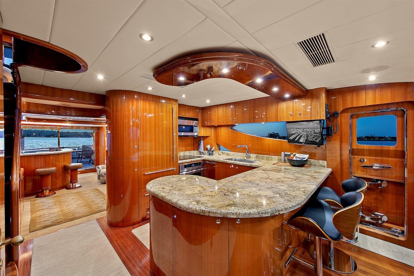 a large kitchen with a bar and bar aboard PAPA'S PLACE Yacht for Sale