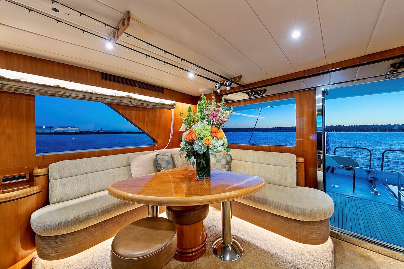a room with a table and a couch aboard PAPA'S PLACE Yacht for Sale