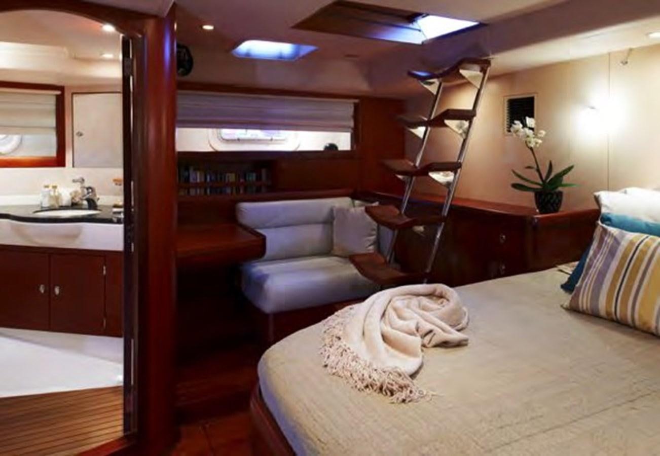 a bedroom with a bed and a ladder aboard TILLYMINT Yacht for Sale