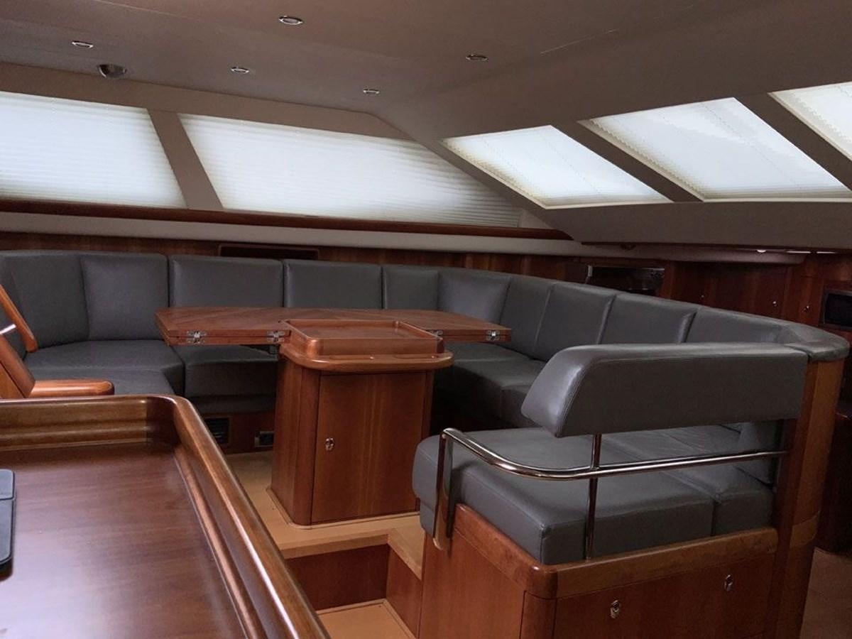 a room with seats and a bench aboard BILL AND ME Yacht for Sale