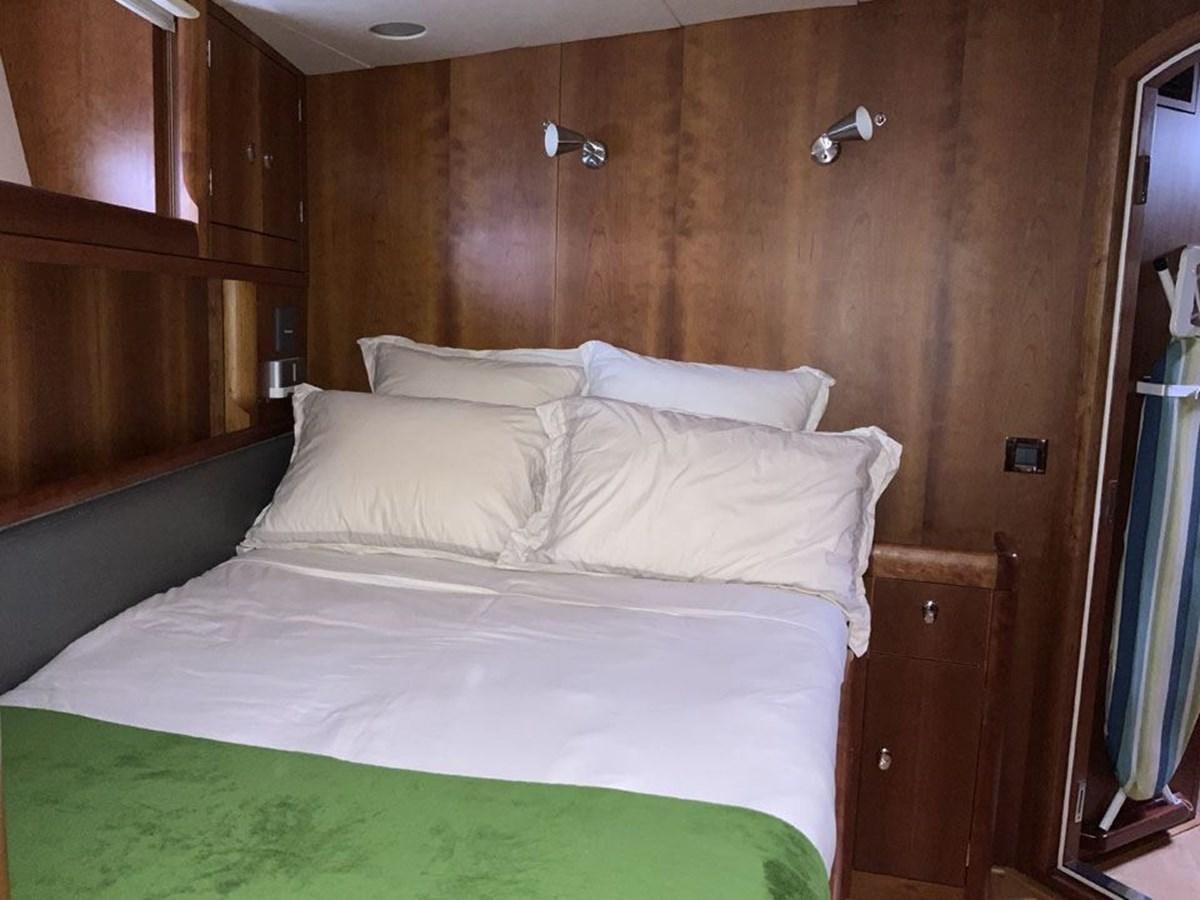 a bed with white sheets aboard BILL AND ME Yacht for Sale
