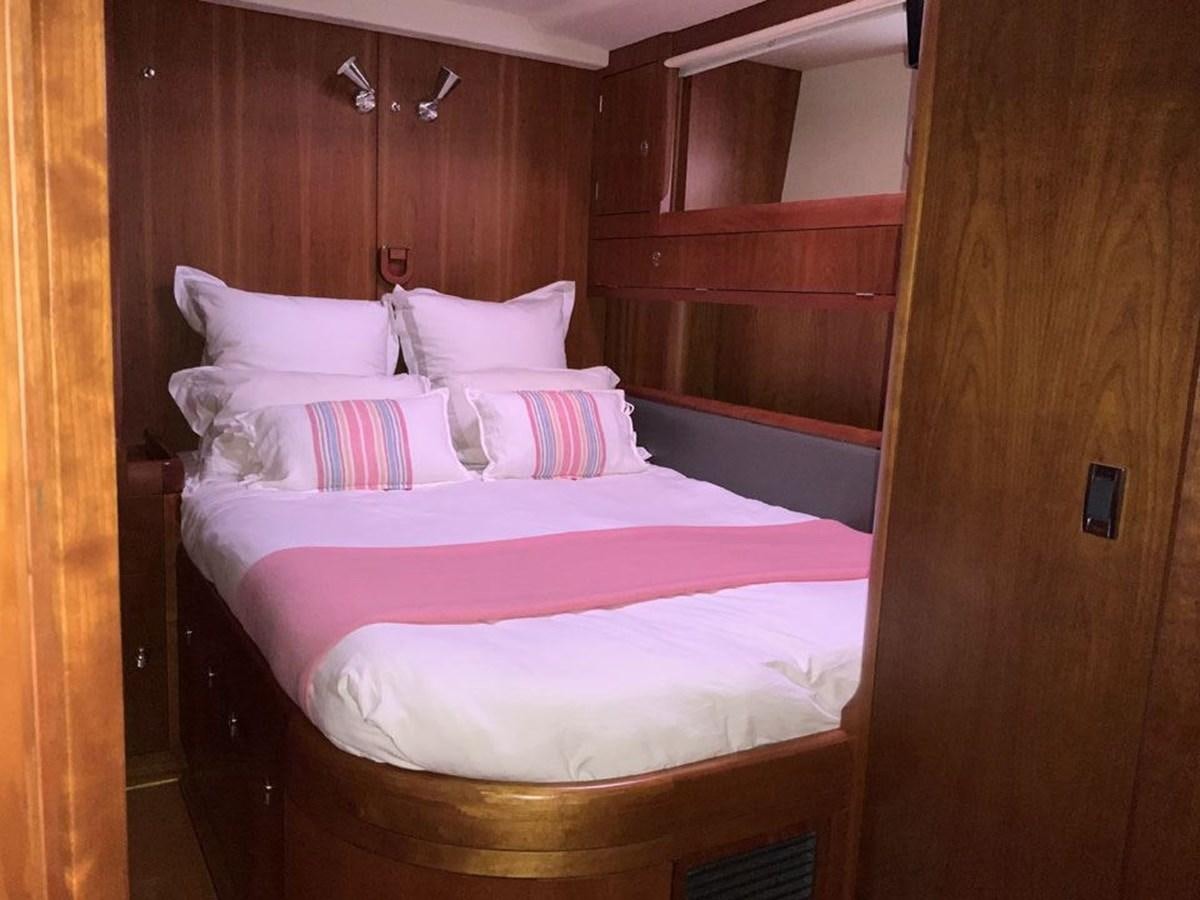 a bed with white sheets aboard BILL AND ME Yacht for Sale