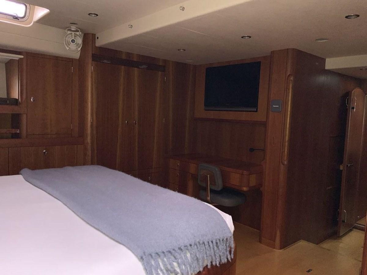 a room with a bed and a television aboard BILL AND ME Yacht for Sale