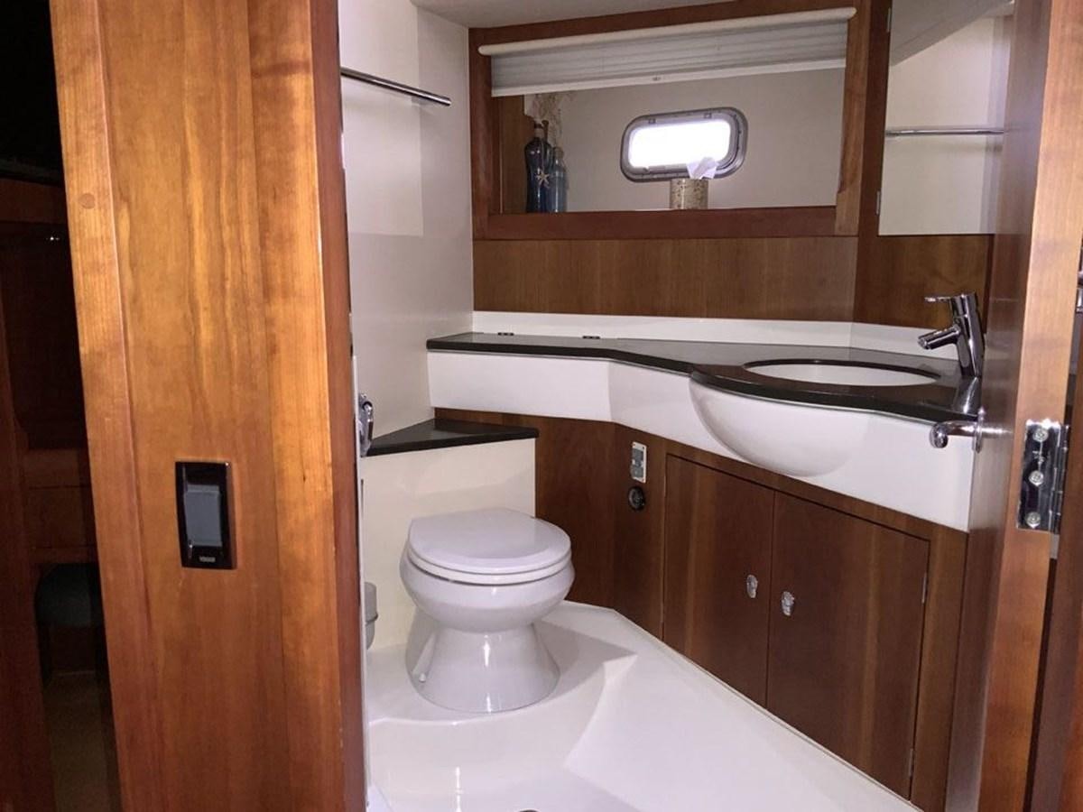 a bathroom with a toilet and sink aboard BILL AND ME Yacht for Sale