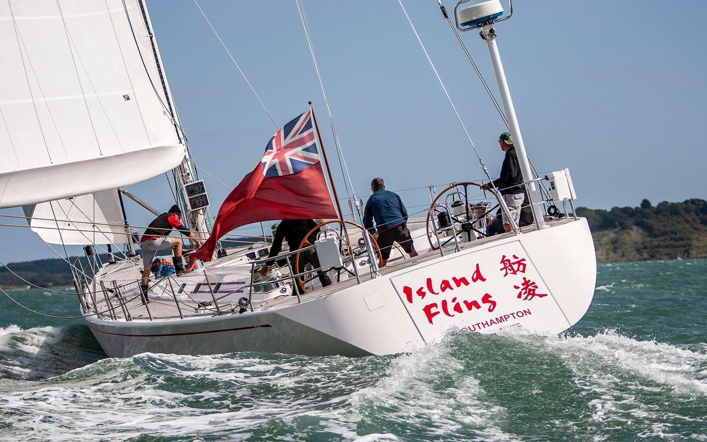 a boat with a flag on it aboard ISLAND FLING Yacht for Sale