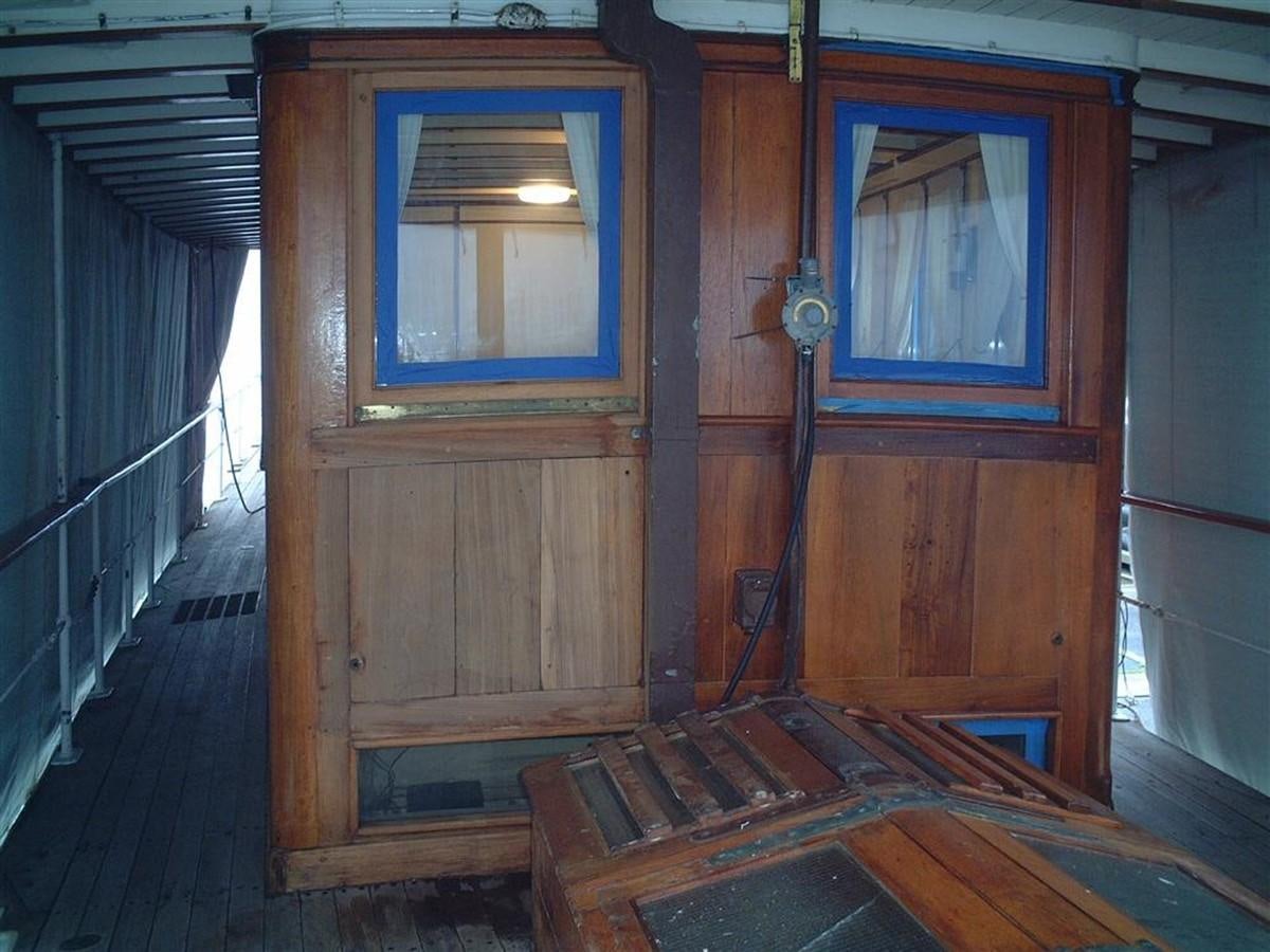 a wooden cabin with a door aboard SYRENE I Yacht for Sale