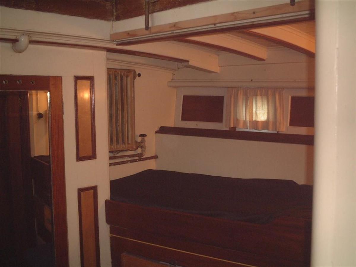 a room with a bed and a window aboard SYRENE I Yacht for Sale