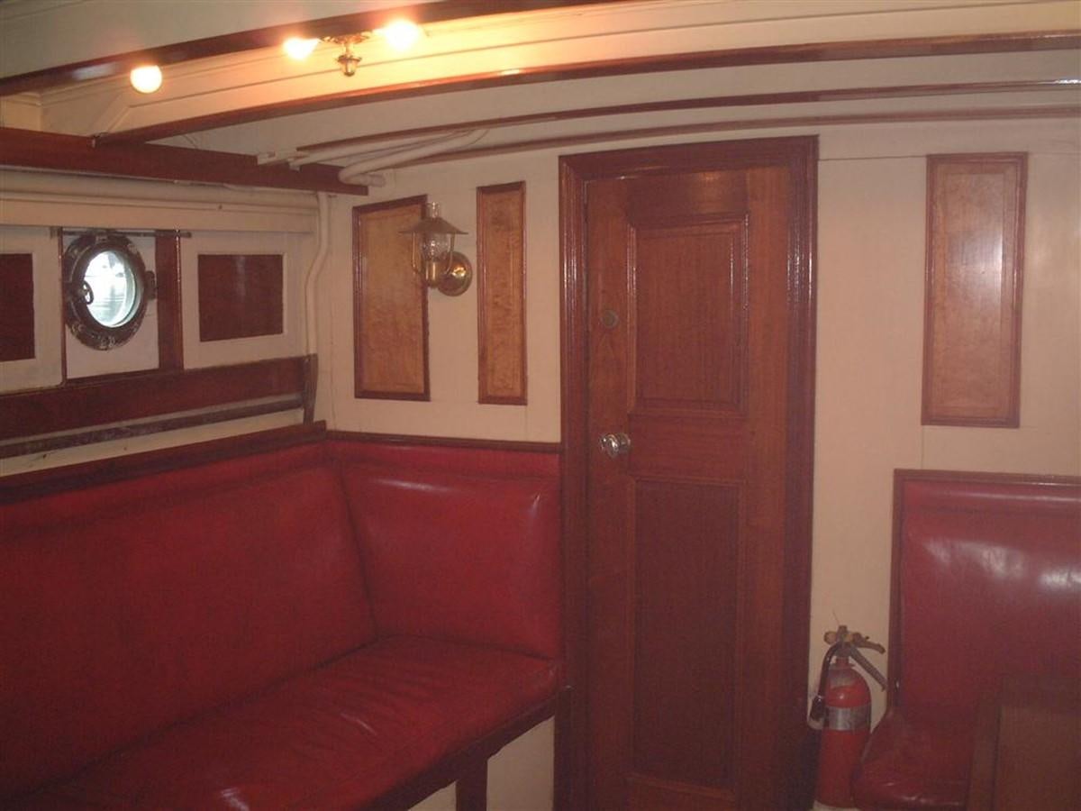 a room with a couch and a mirror aboard SYRENE I Yacht for Sale