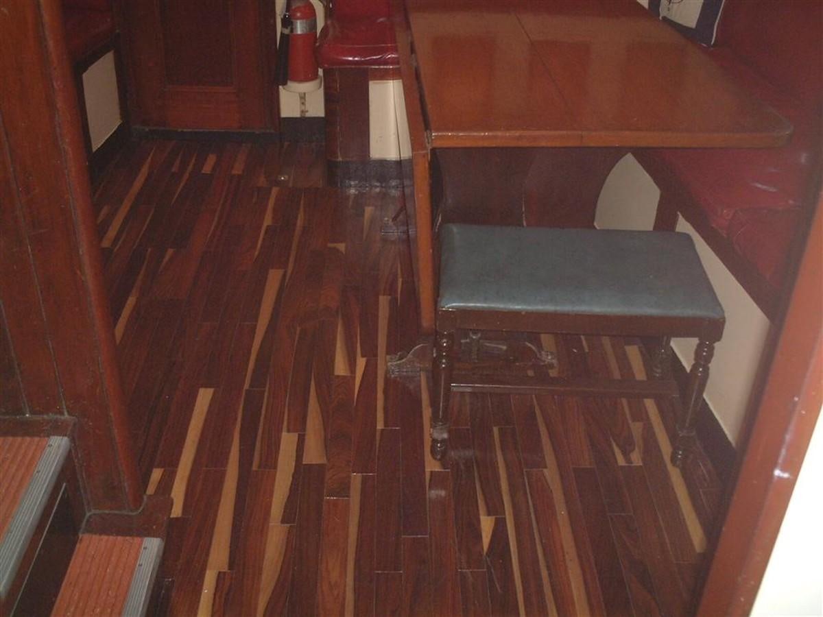 a wood table with a bench aboard SYRENE I Yacht for Sale