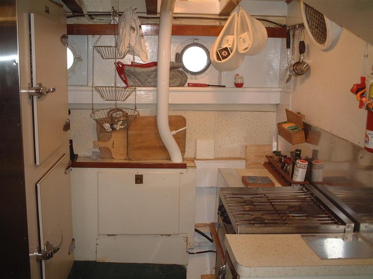 a kitchen with a stove and pots aboard SYRENE I Yacht for Sale