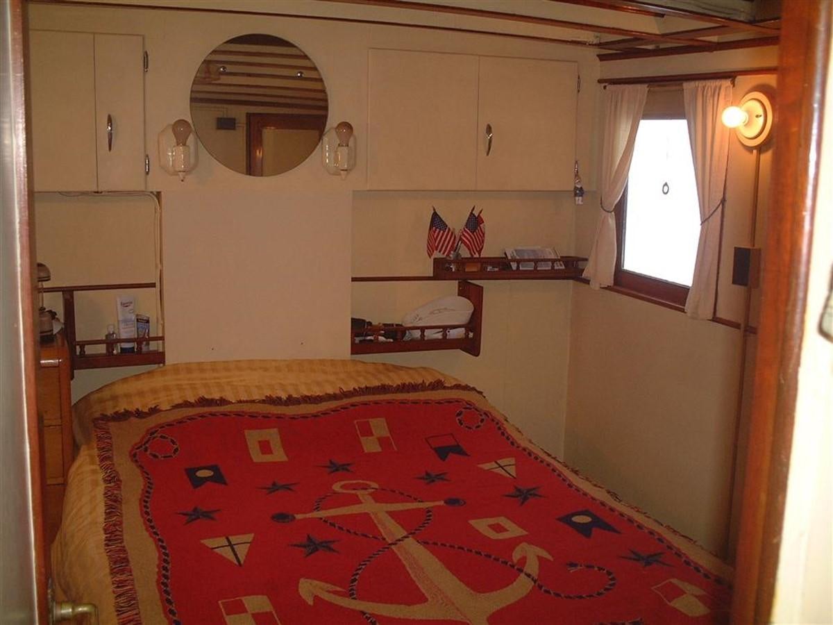 a bedroom with a bed and a mirror aboard SYRENE I Yacht for Sale
