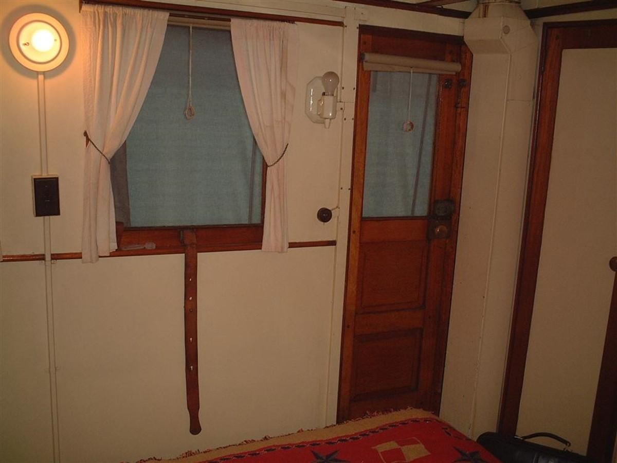 a room with a bed and a door aboard SYRENE I Yacht for Sale