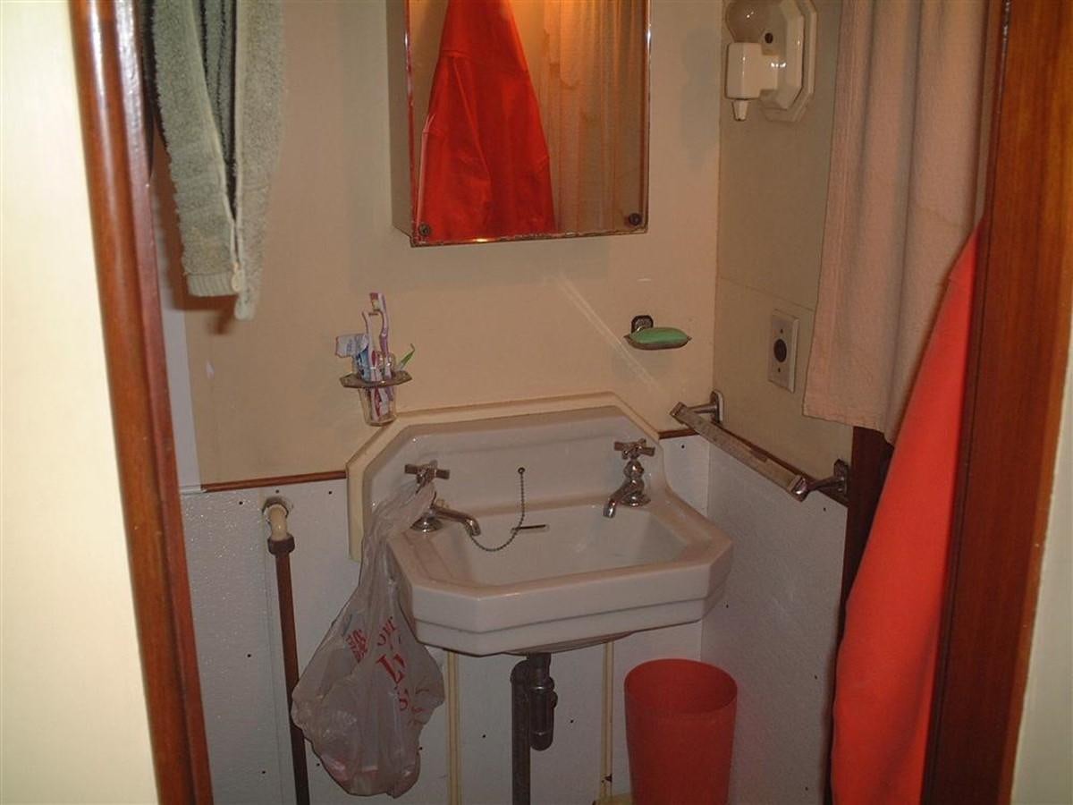a bathroom with a sink and mirror aboard SYRENE I Yacht for Sale