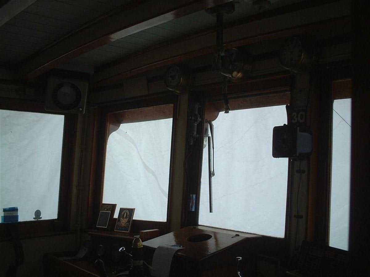 a room with a window and a table with a lamp on it aboard SYRENE I Yacht for Sale