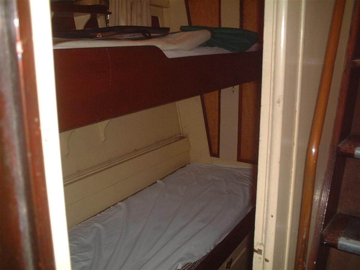 a bed with a white sheet aboard SYRENE I Yacht for Sale