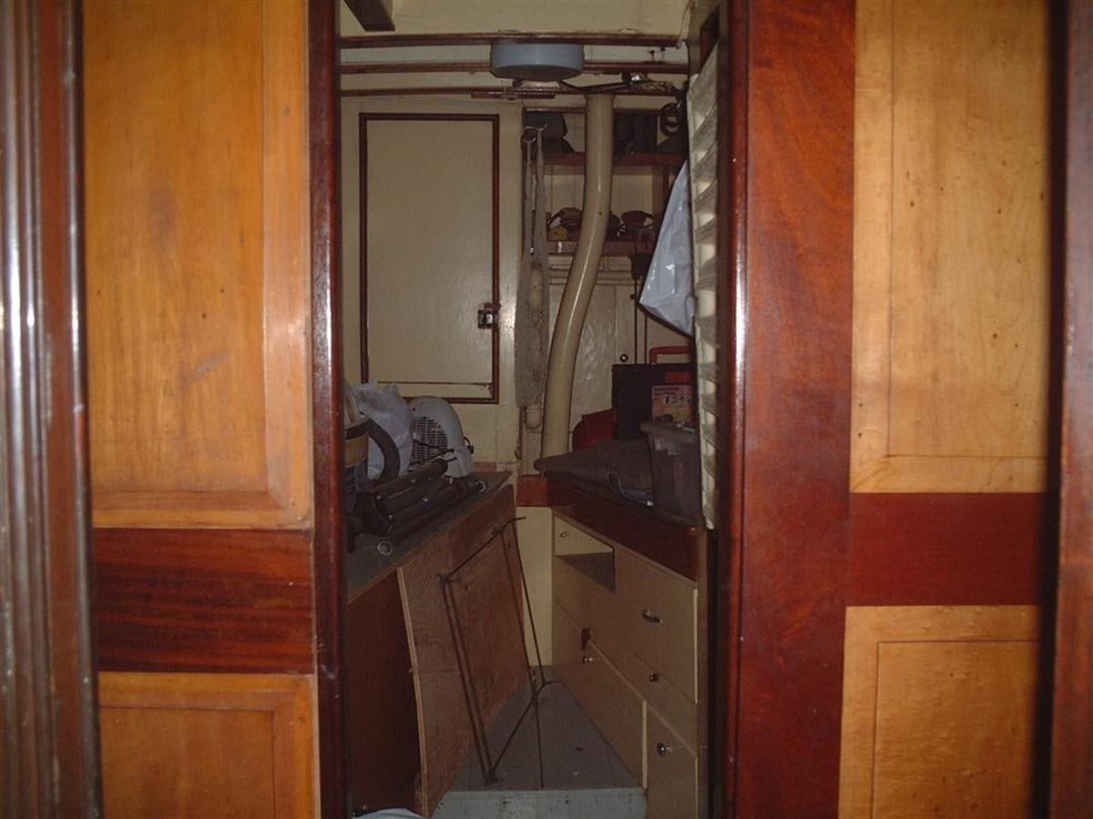a room with a messy desk and a closet aboard SYRENE I Yacht for Sale