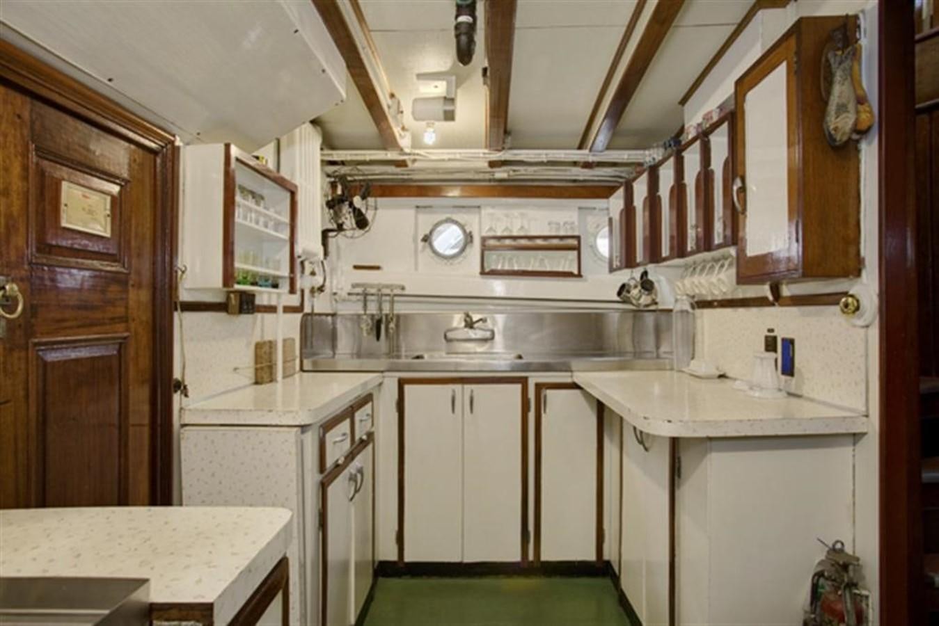 a kitchen with white cabinets aboard SYRENE I Yacht for Sale