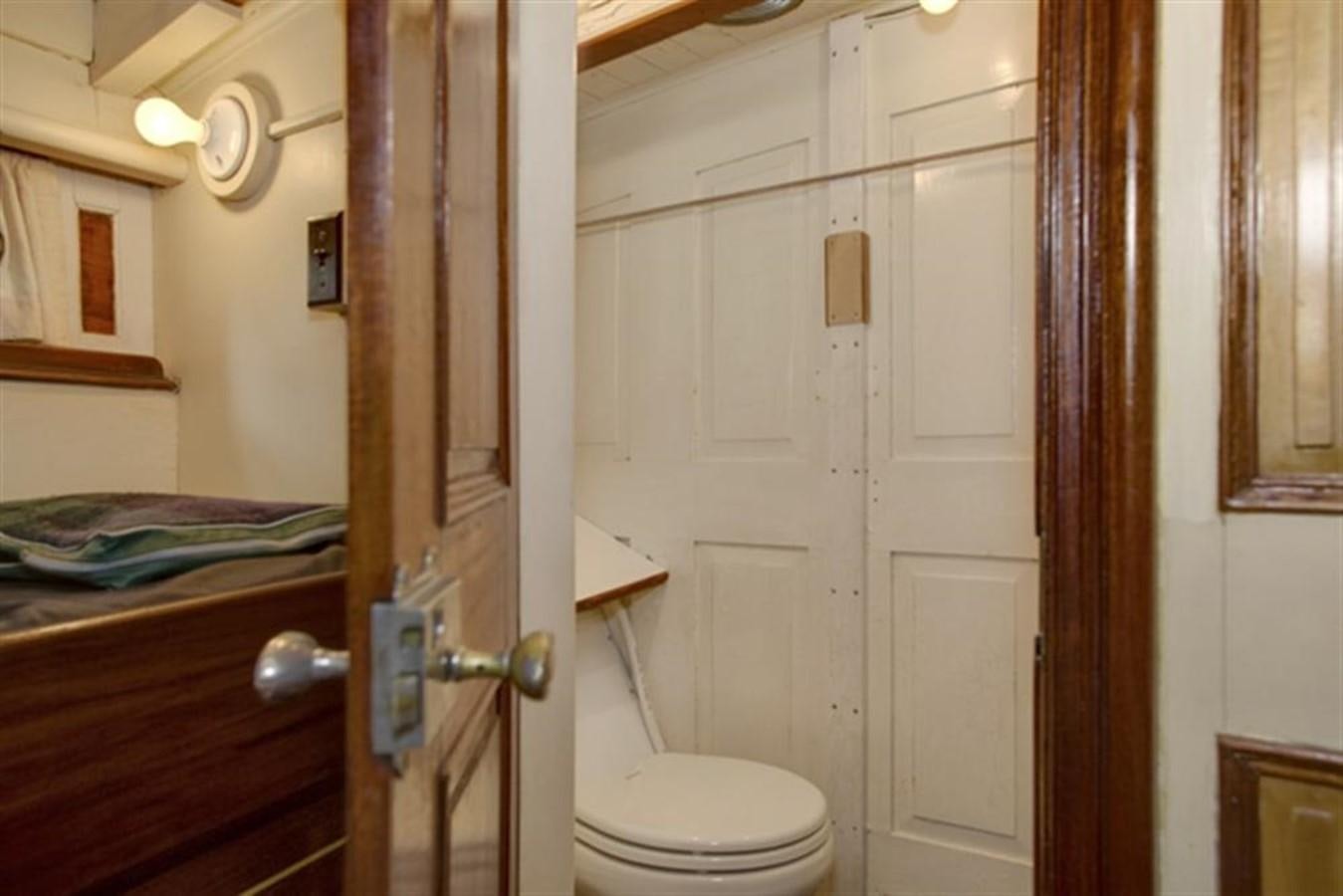 a bathroom with a toilet and a sink aboard SYRENE I Yacht for Sale