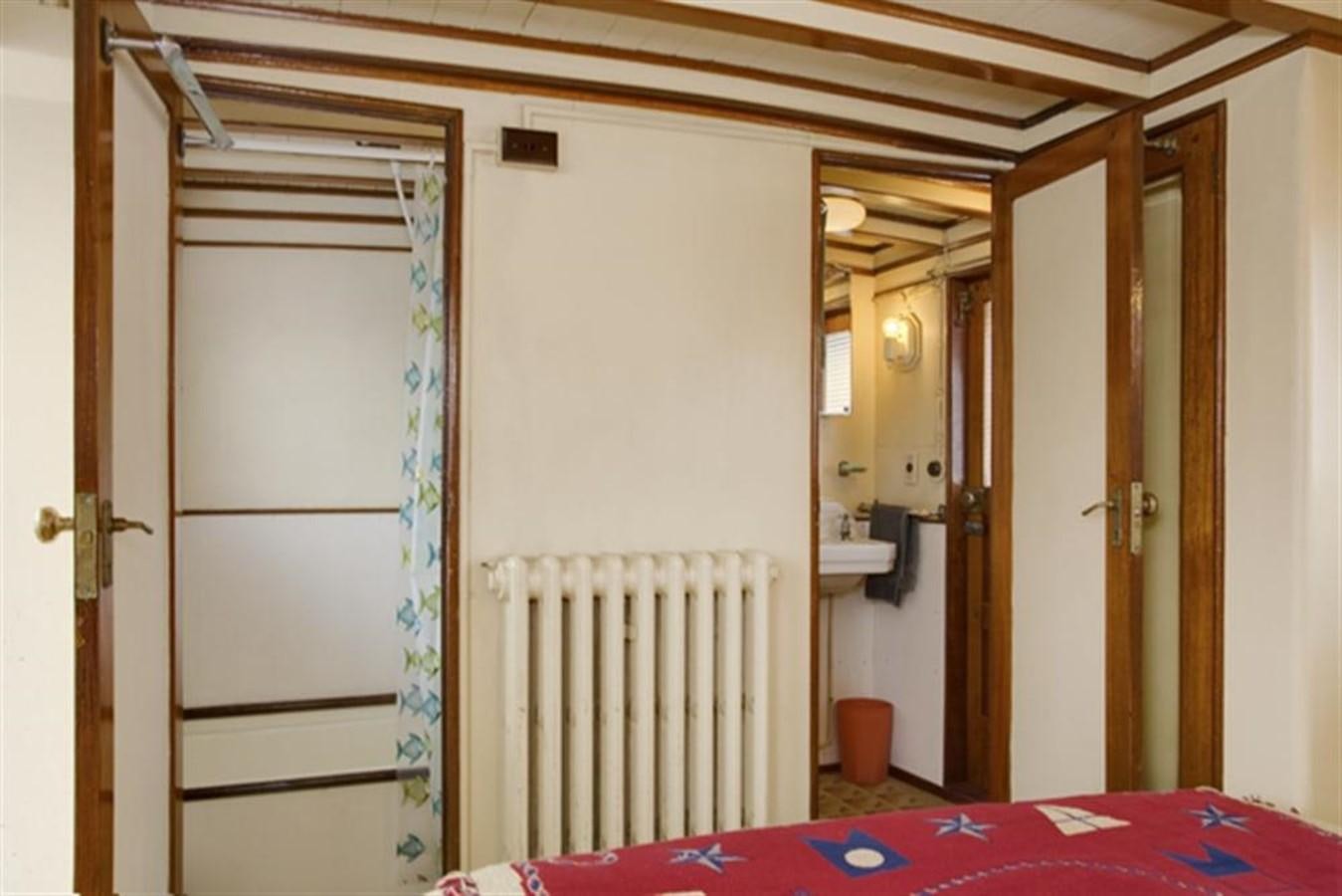 a room with a bed and a closet aboard SYRENE I Yacht for Sale