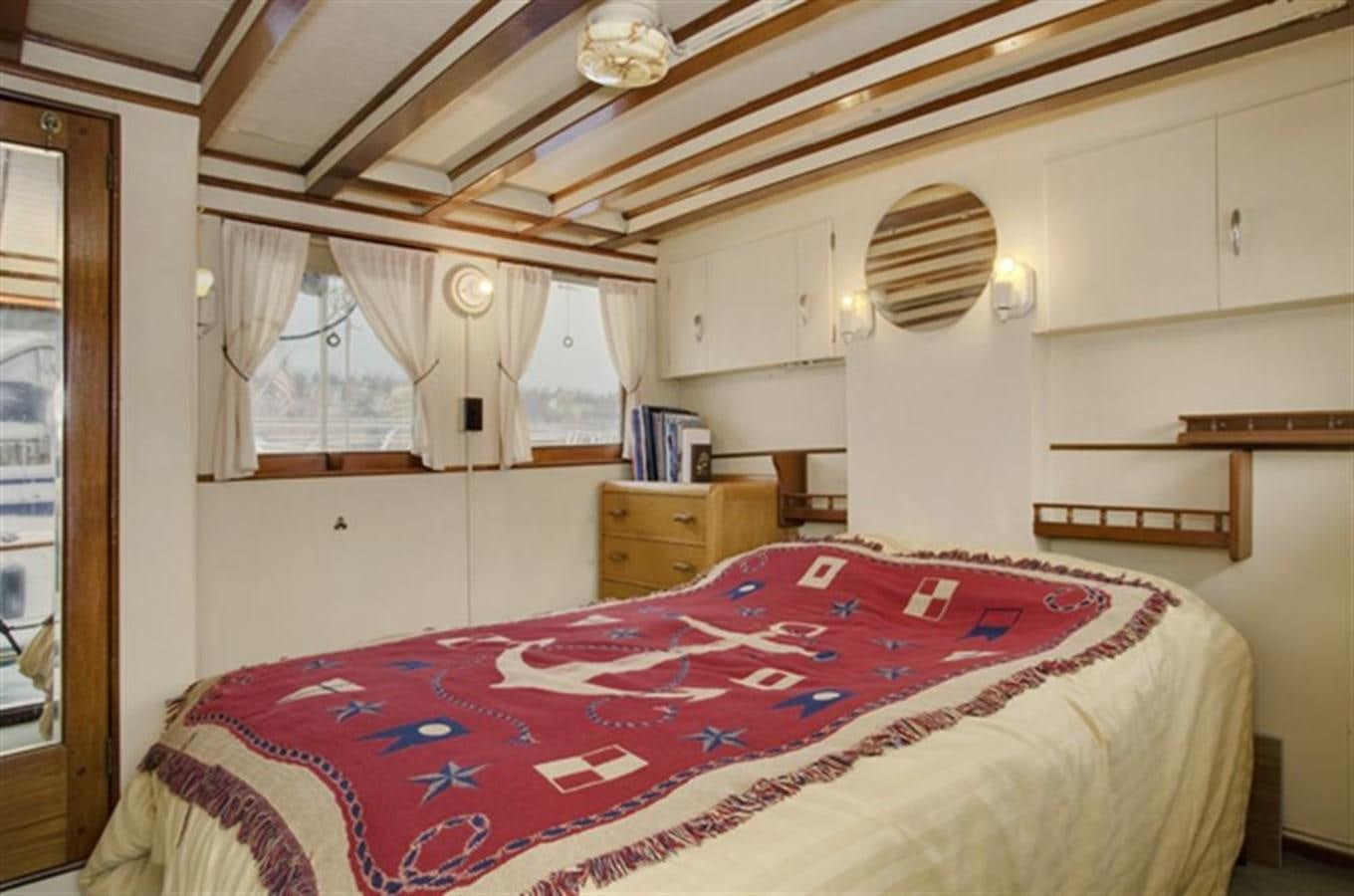 a bedroom with a bed and a window aboard SYRENE I Yacht for Sale
