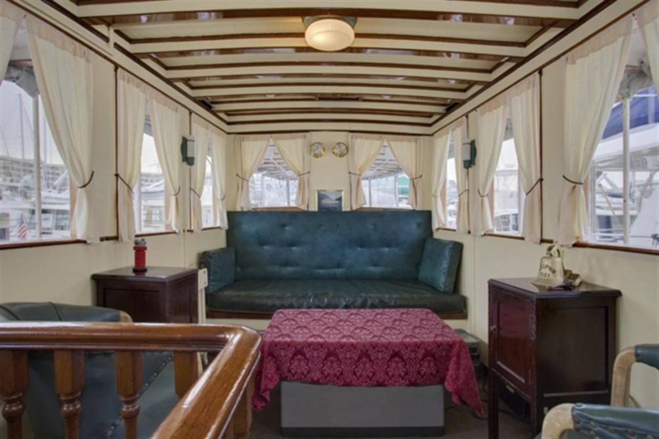 a living room with a couch and a table aboard SYRENE I Yacht for Sale