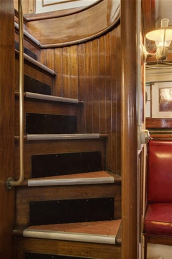 a wooden shelf with a bookcase aboard SYRENE I Yacht for Sale