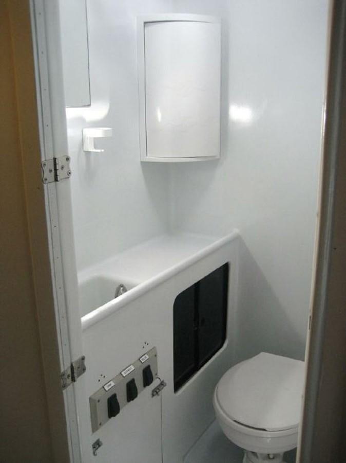 a small bathroom with a toilet aboard ROTHMANS Yacht for Sale