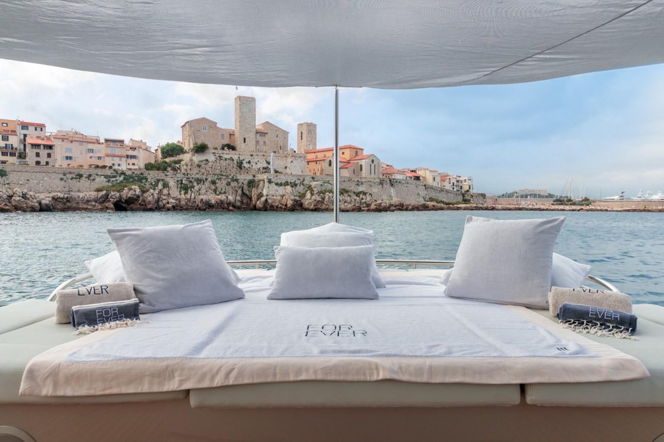 a bed with pillows on it aboard FOR EVER Yacht for Sale
