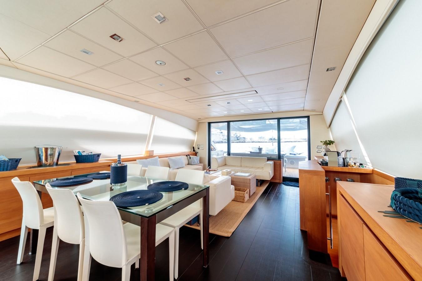 a room with tables and chairs aboard FOR EVER Yacht for Sale