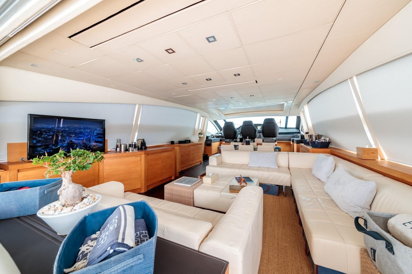 a room with couches and a television aboard FOR EVER Yacht for Sale