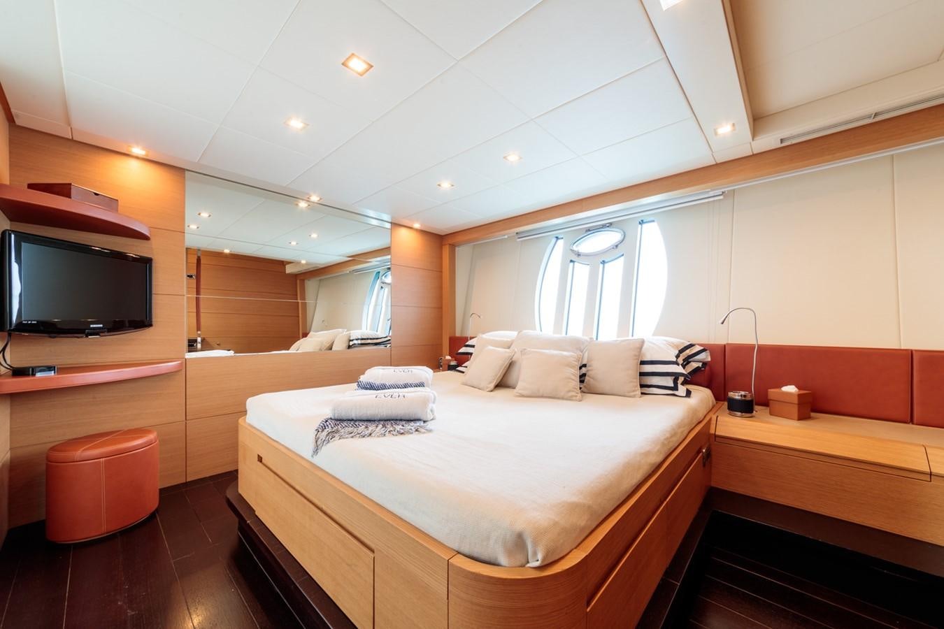 a room with a bed and a television aboard FOR EVER Yacht for Sale