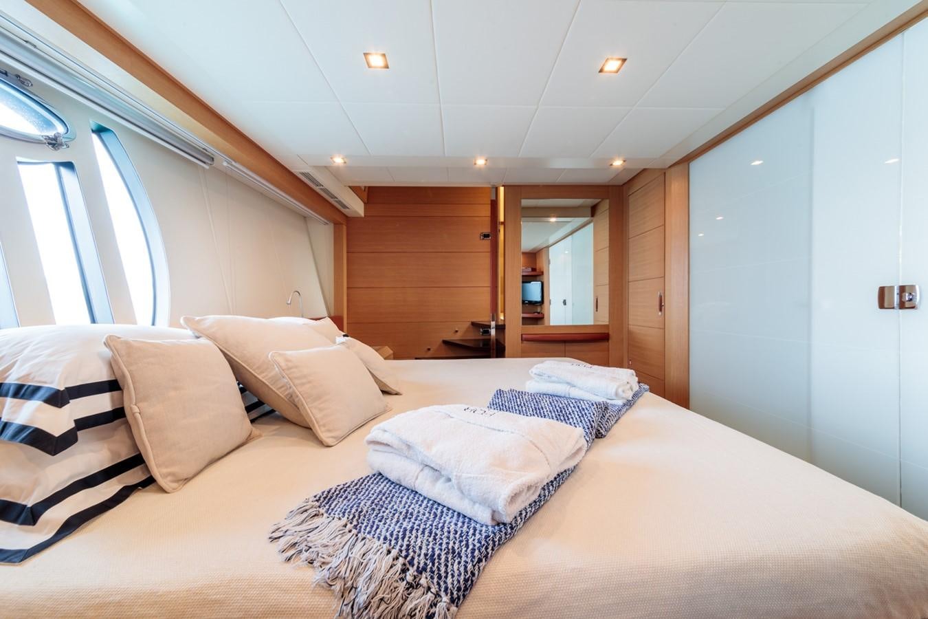 a bed with pillows and a mirror aboard FOR EVER Yacht for Sale