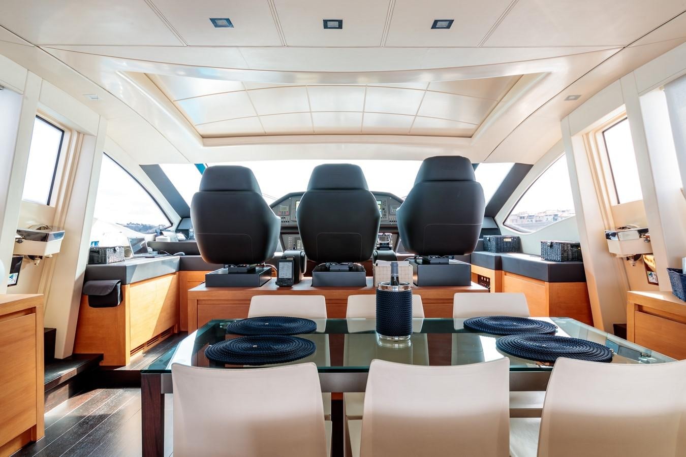 a room with chairs and tables aboard FOR EVER Yacht for Sale