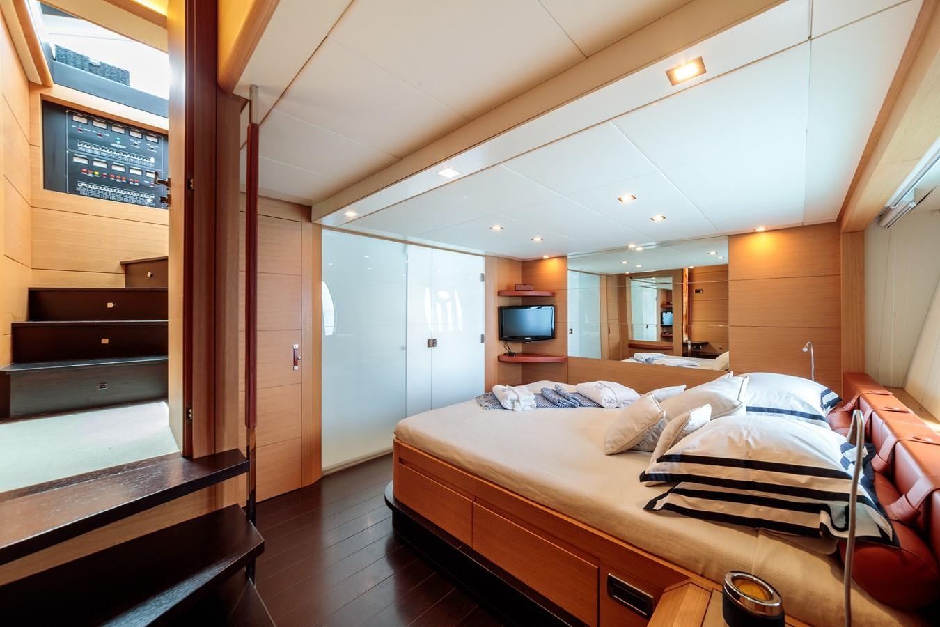 a room with a bed and a piano aboard FOR EVER Yacht for Sale