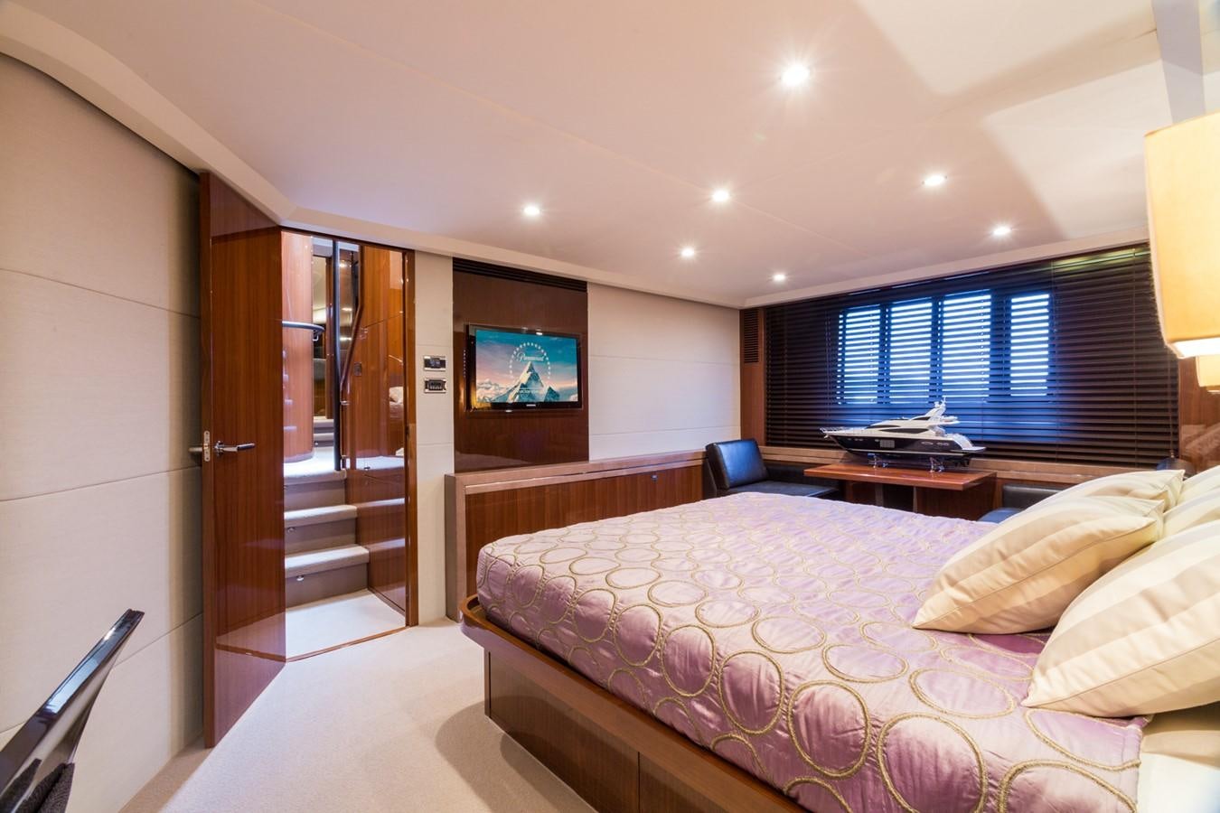 a hotel room with a bed and tv aboard PRINCESS 78 MY Yacht for Sale