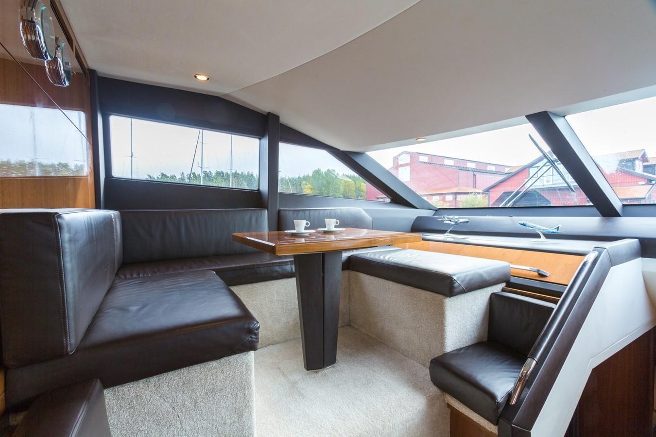 a room with couches and a table aboard PRINCESS 78 MY Yacht for Sale