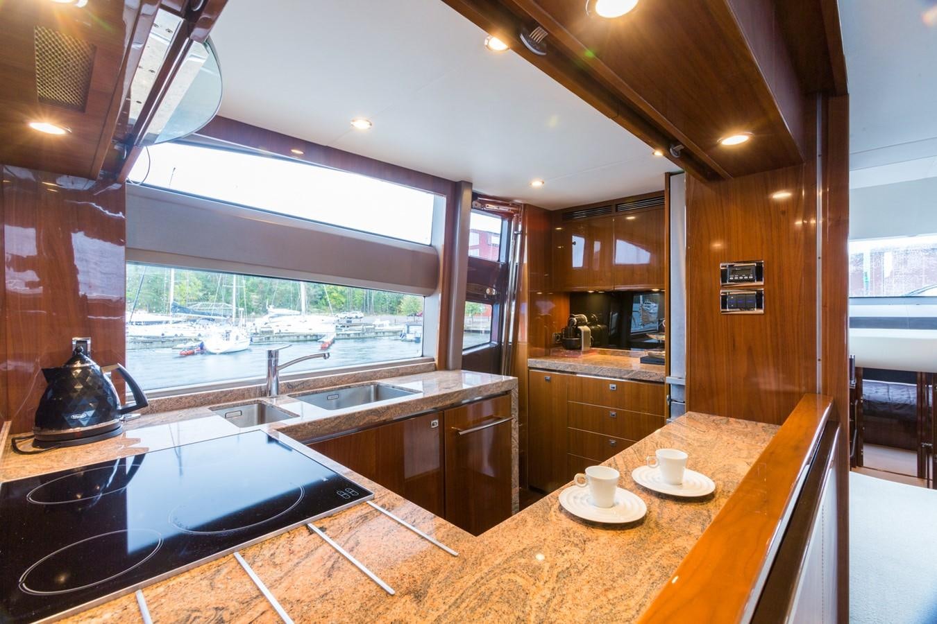 a kitchen with a large island aboard PRINCESS 78 MY Yacht for Sale